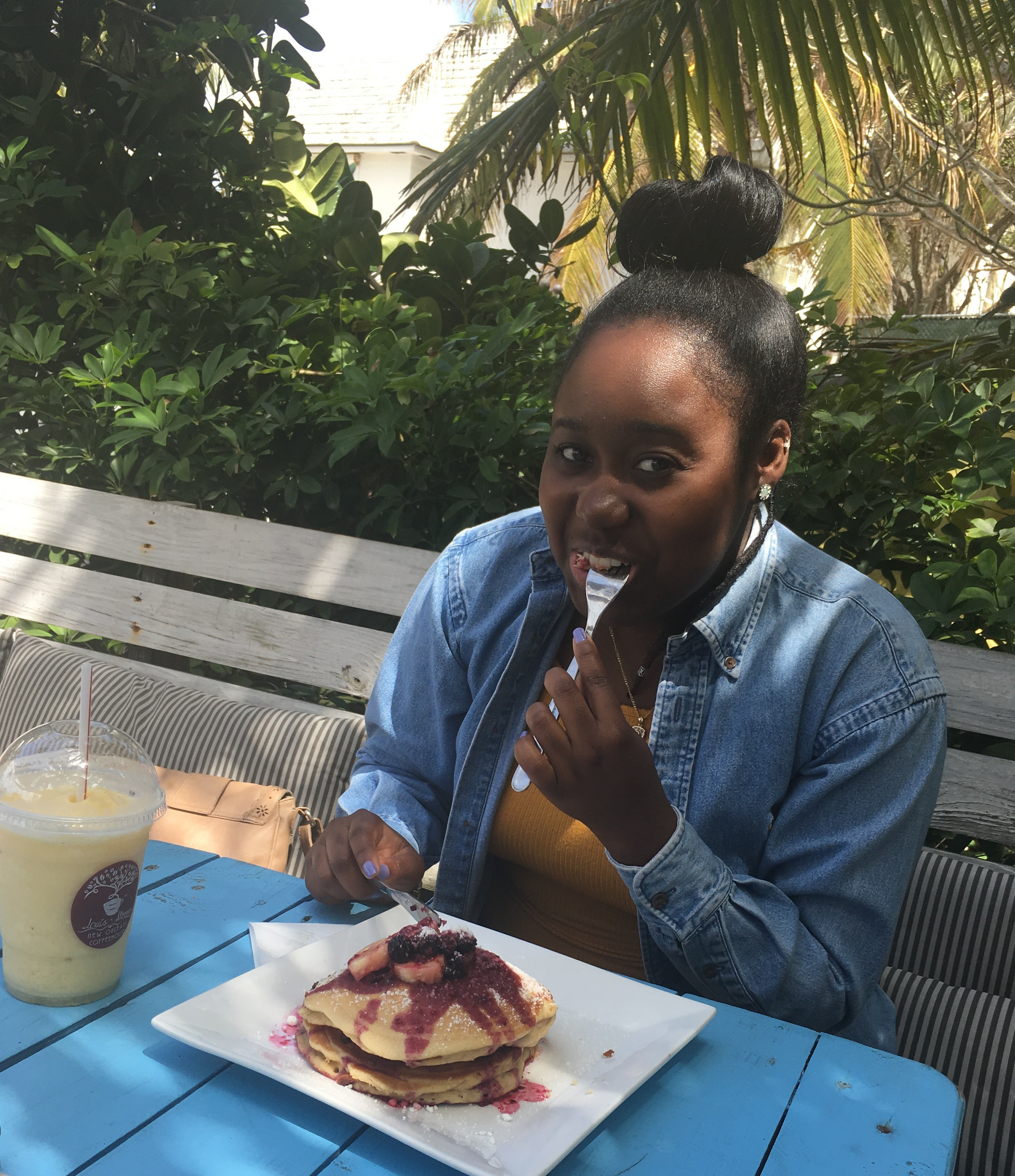 Eating nutella pancakes topped with mixed berry sauce